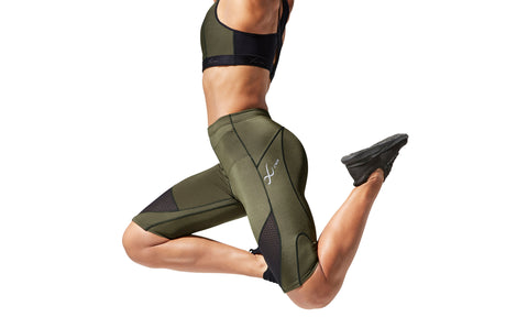 female athlete wearing CW-X compression shorts model Stabilyx Ventilator in color Forest Night