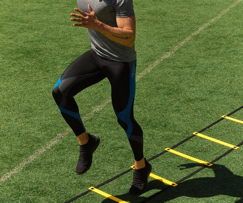 male cross-training on turf wearing cw-x compression tights