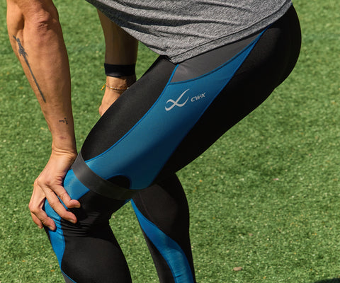 male standing after a workout wearing cw-x compression tights